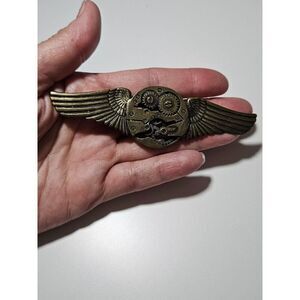 Bronze colored gear wing pin